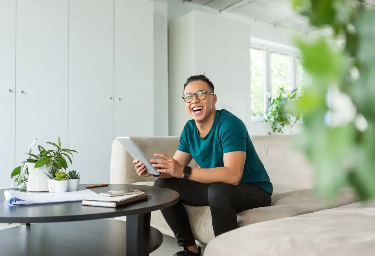 Asian handsome young man sitting in an office and using digital tablet. Hipster working in creative workplace.
