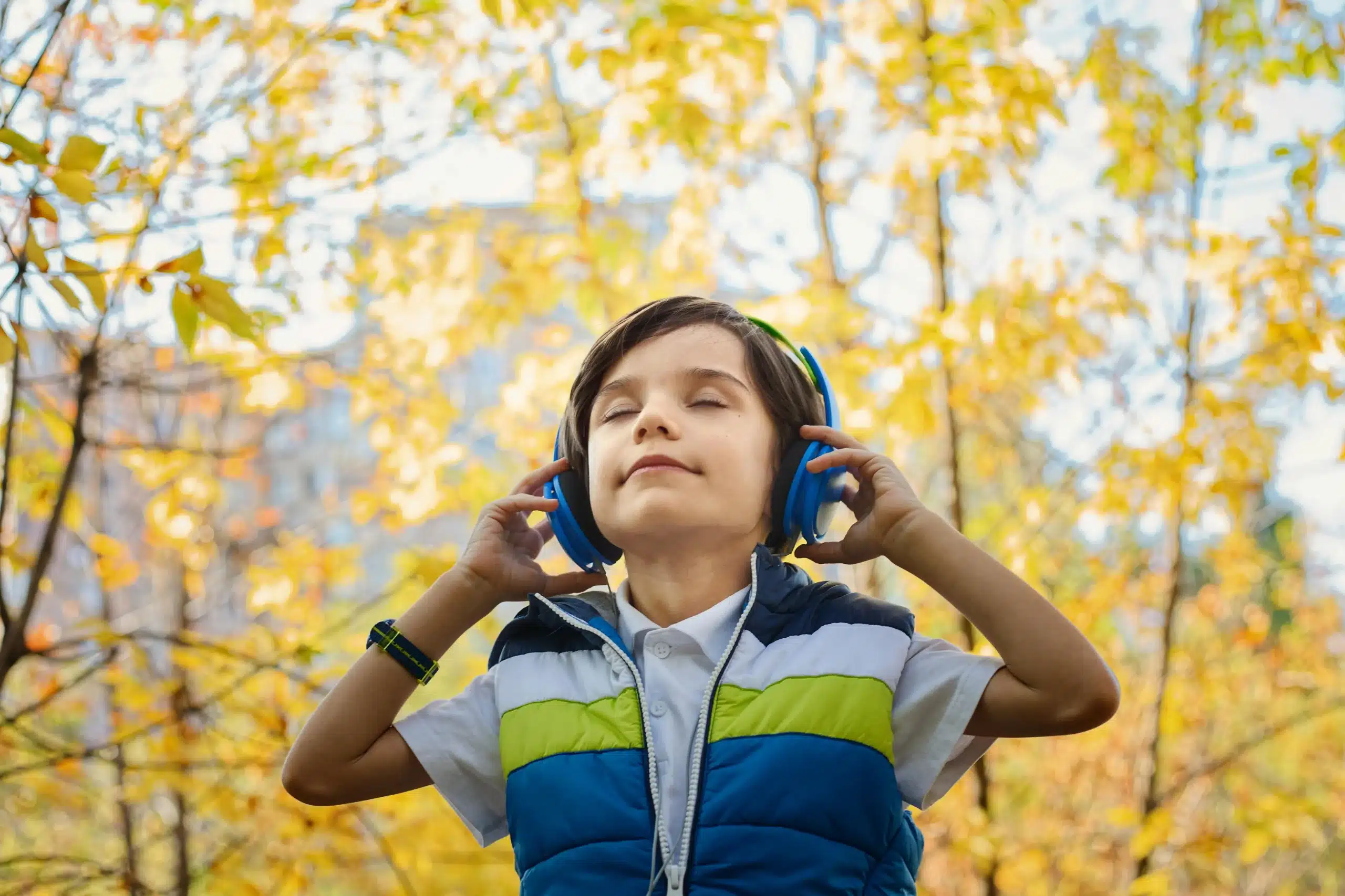  Boy wearing headphones eyes closed feeling calm find healing with therapy for children in Austin Texas peaceful moment