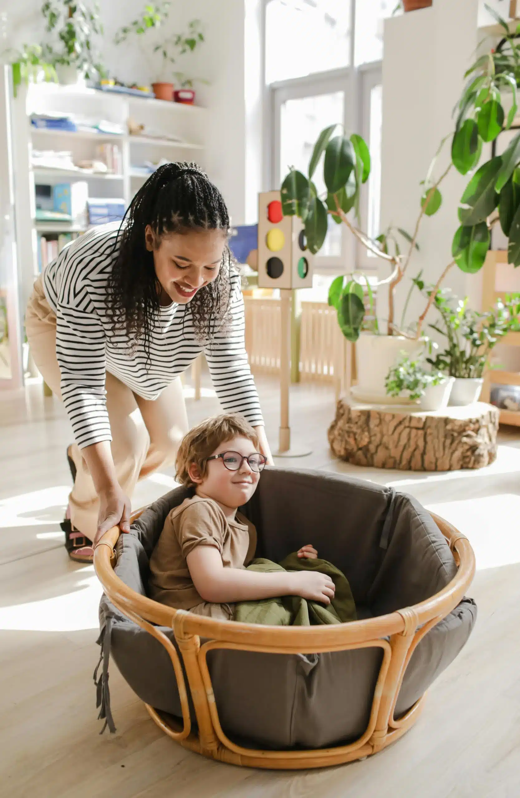  Mother gently moving son in chair showing care support and nurturing presence in shared emotional connection moment