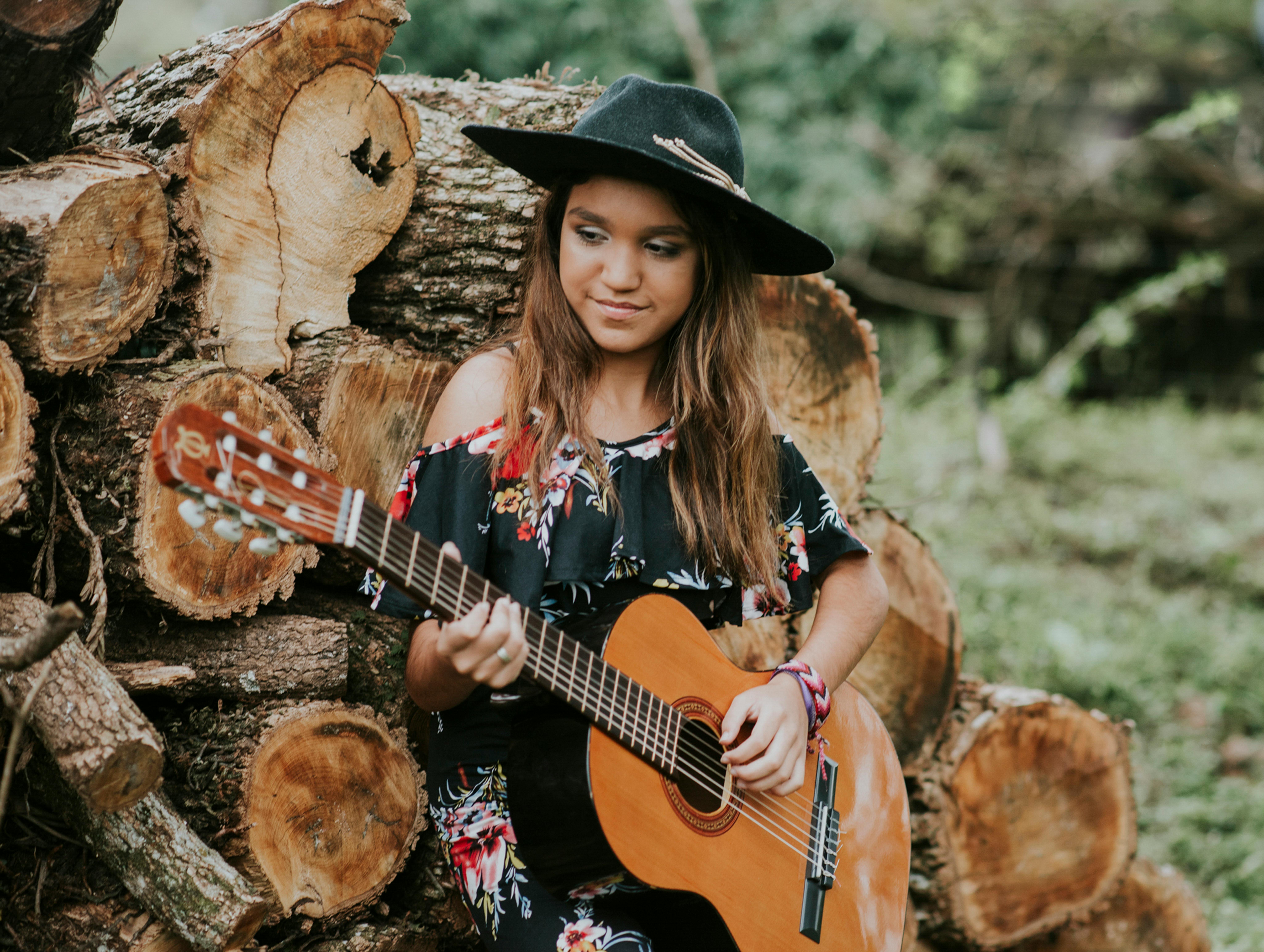 A girl playing guitar, symbolizing music therapy for dementia in Austin, to reach emotions and connection beyond words.