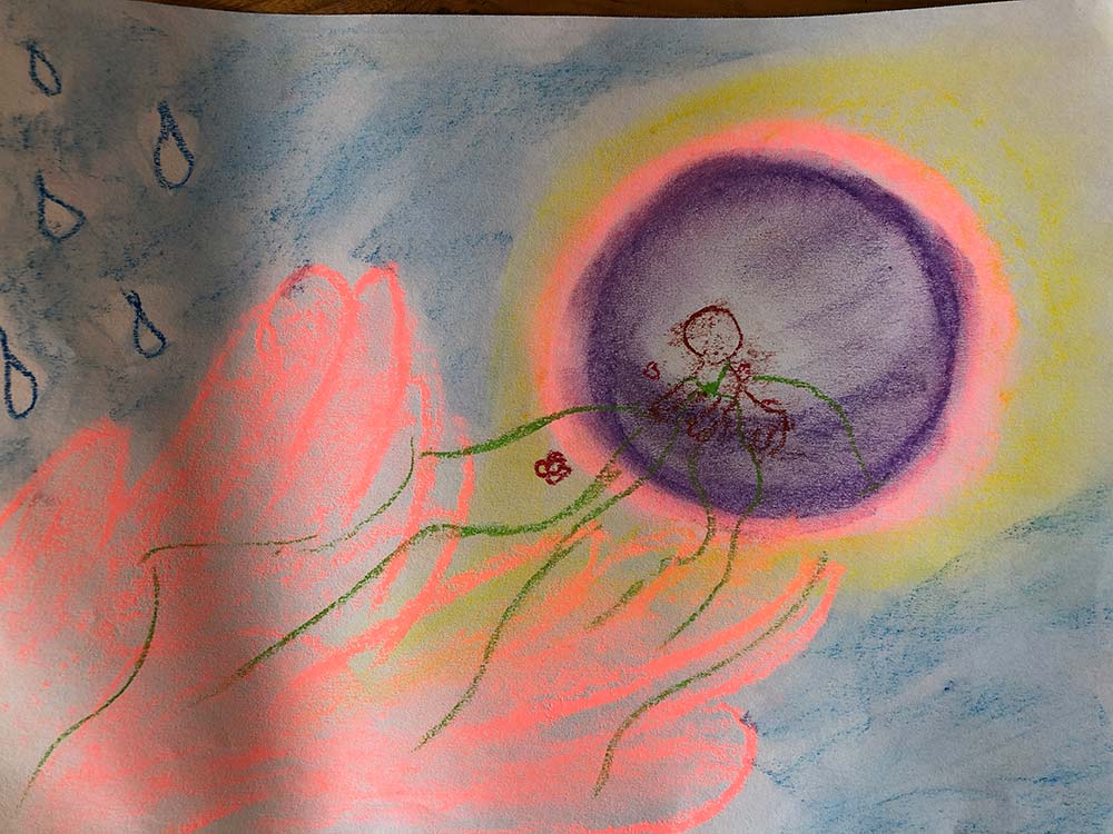 A colorful crayon drawing featuring a purple circle surrounded by yellow and orange glows