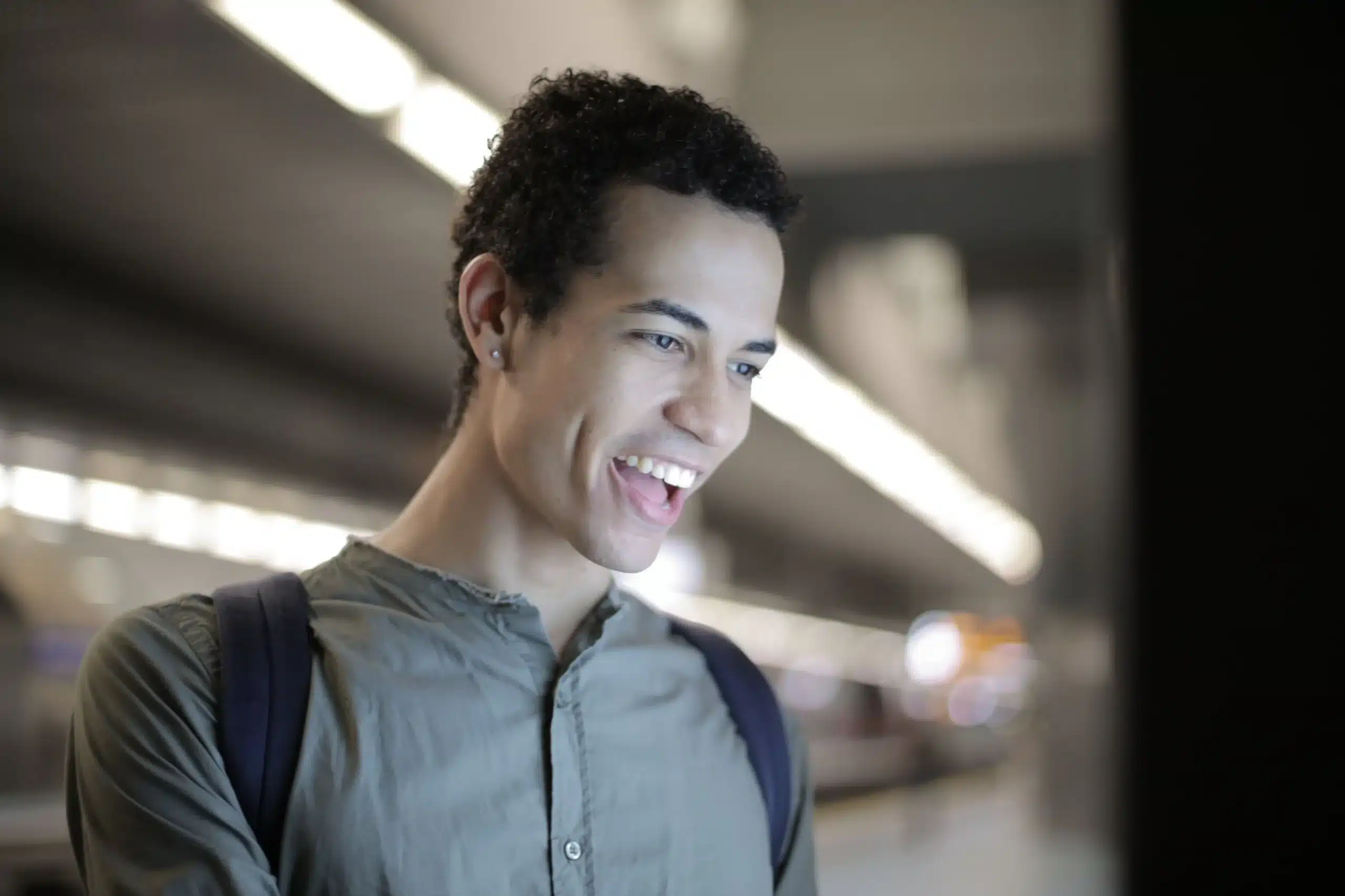 Cheerful young man interacts with a digital device