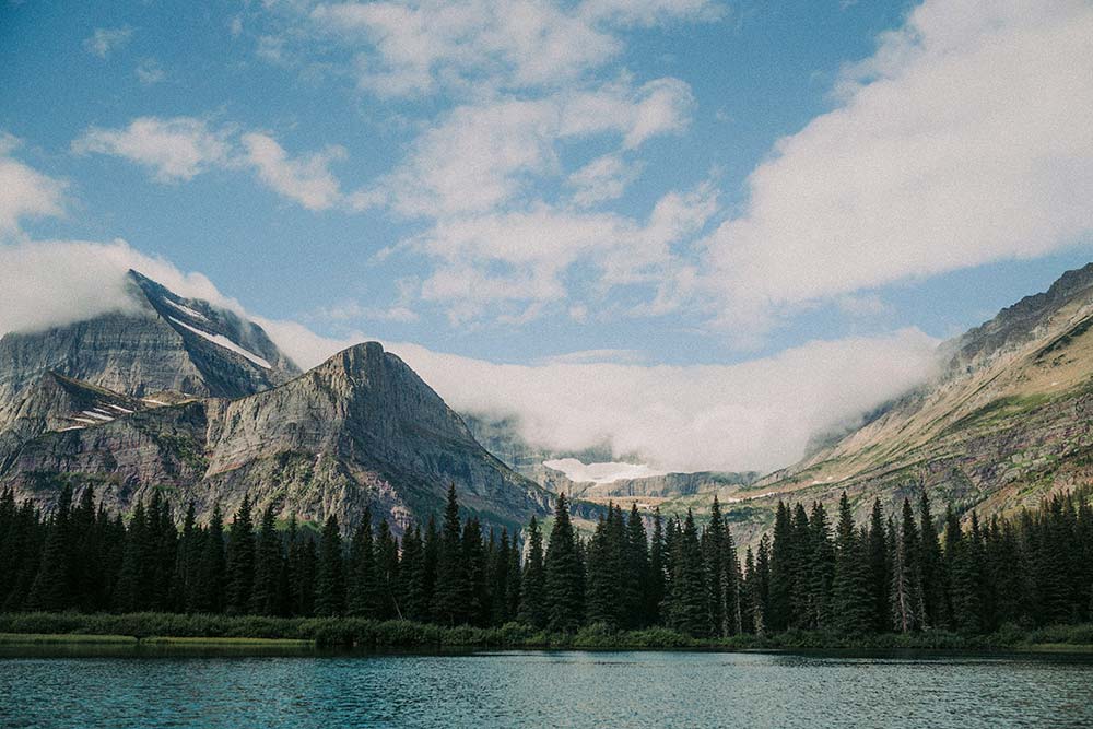 a lake surrounded by mountains and trees