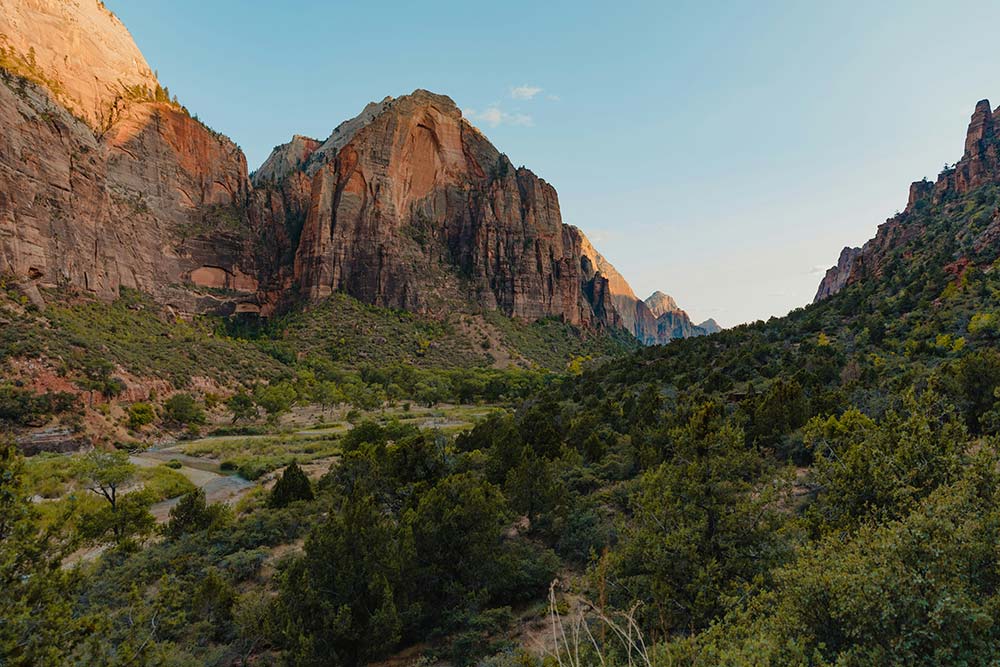 a scenic view of a mountain range with trees