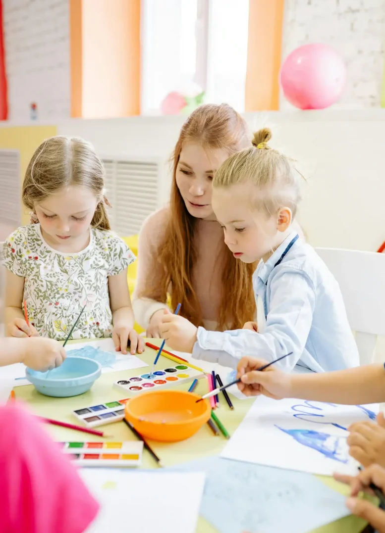 Woman with two children painting together fostering creativity expression bonding and emotional exploration through art
