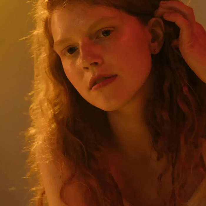 Redhead woman alone - Redhead woman sitting in quiet reflection during emdr therapy Syracuse NY guided by an emdr therapist near me in University Hill