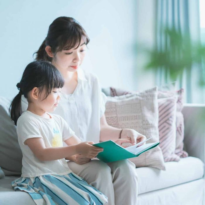 mother and daughter reading a book